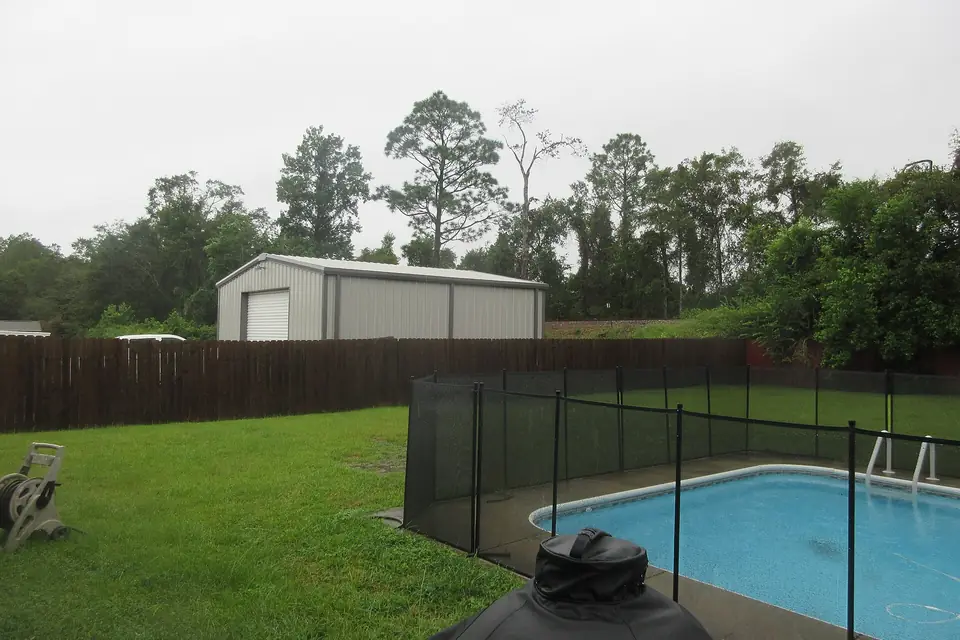 A fenced backyard swimming pool at a home near Pensacola, Florida