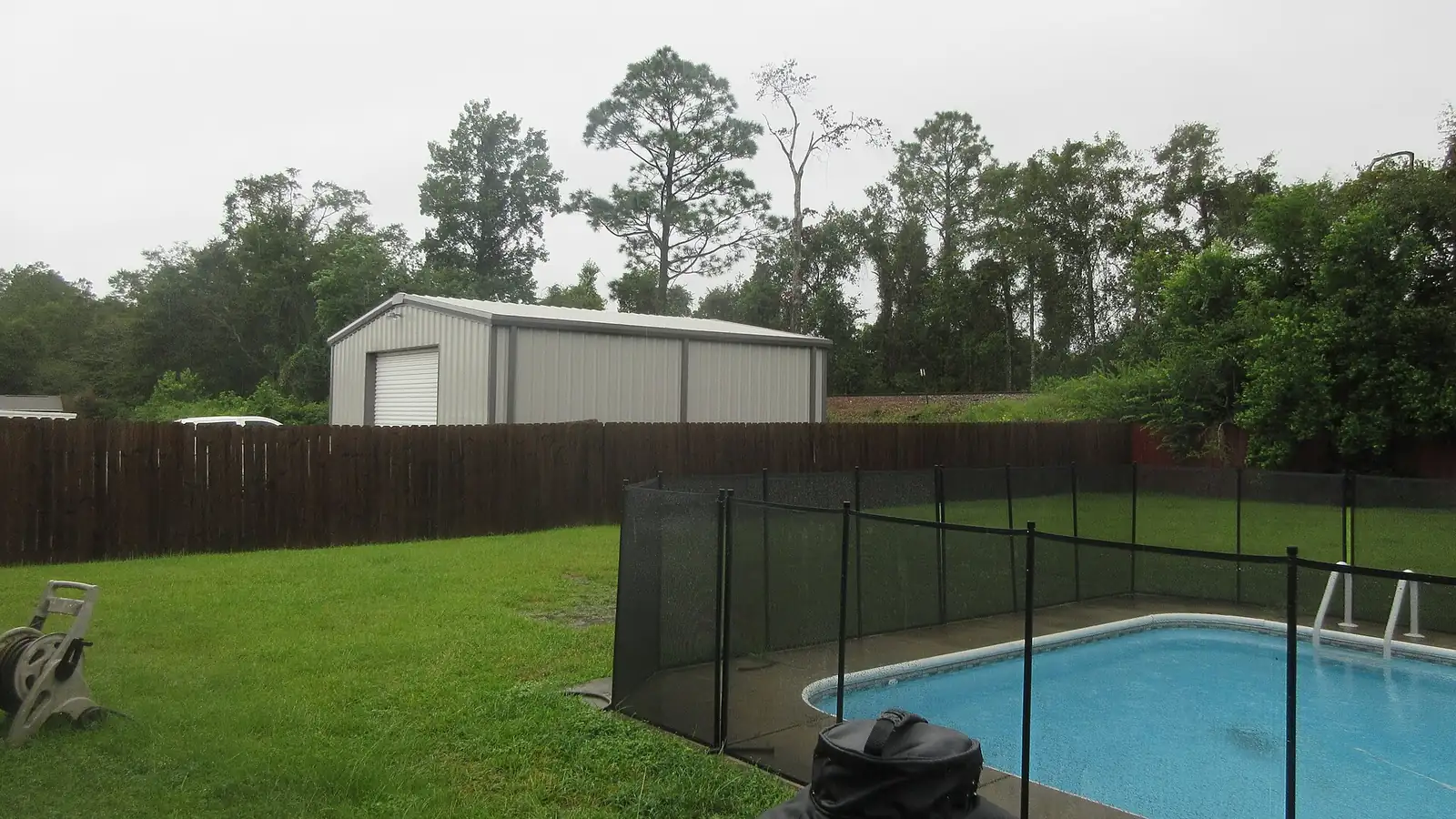 A fenced backyard swimming pool at a home near Pensacola, Florida